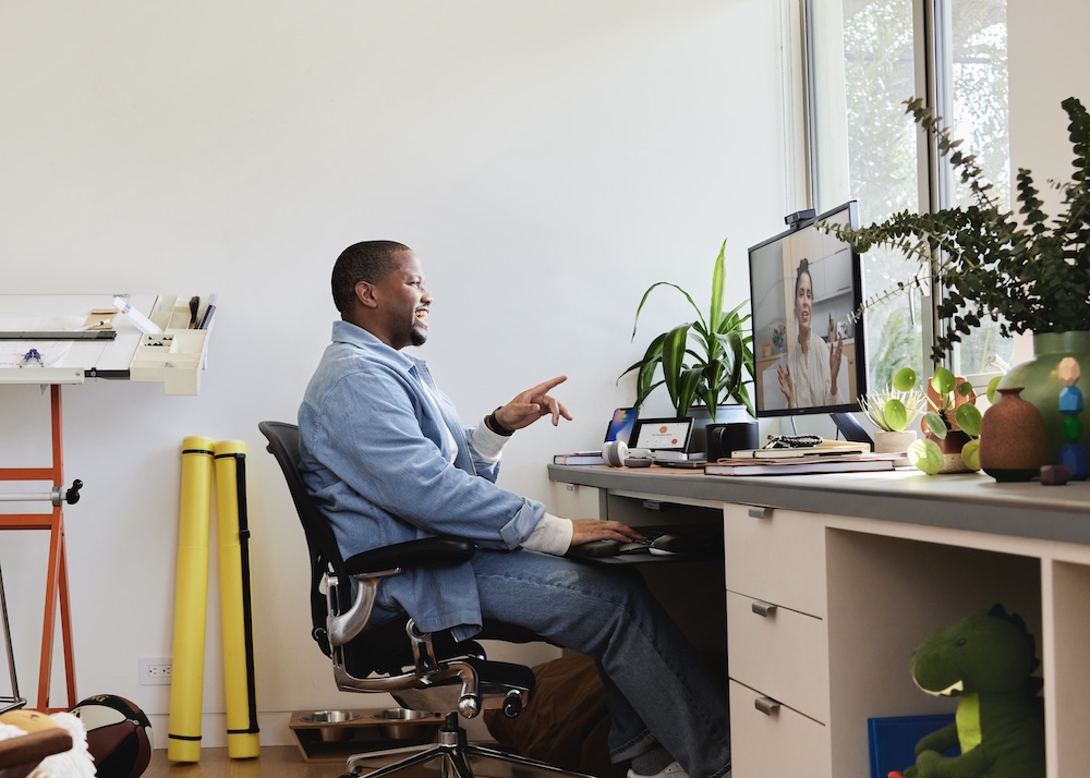 Ein Mann nutzt die Webex Desk Camera für Meetings aus dem Homeoffice